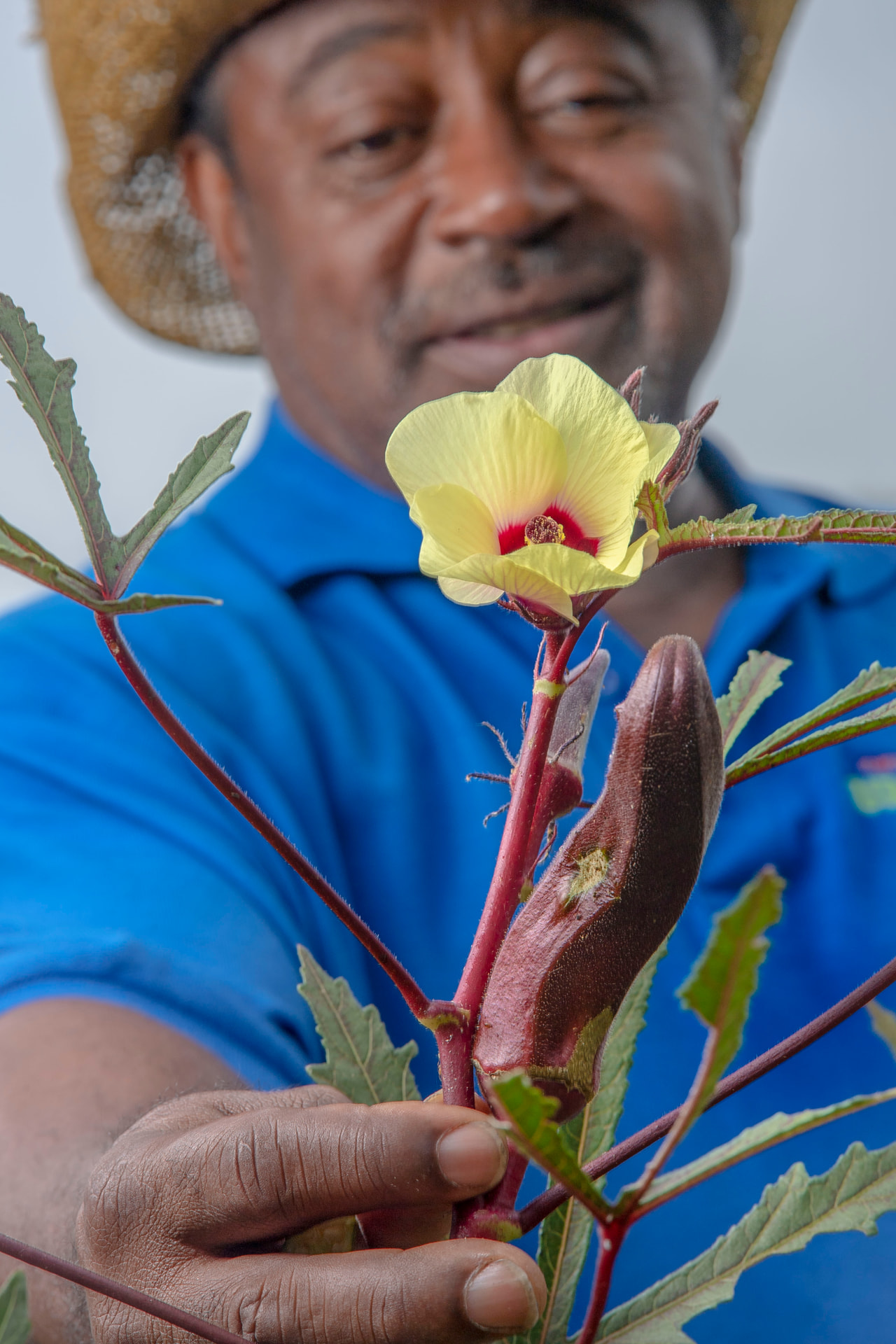 Bobby Wilson sharing an okra flower grown at Metro Atlanta Urban Farm